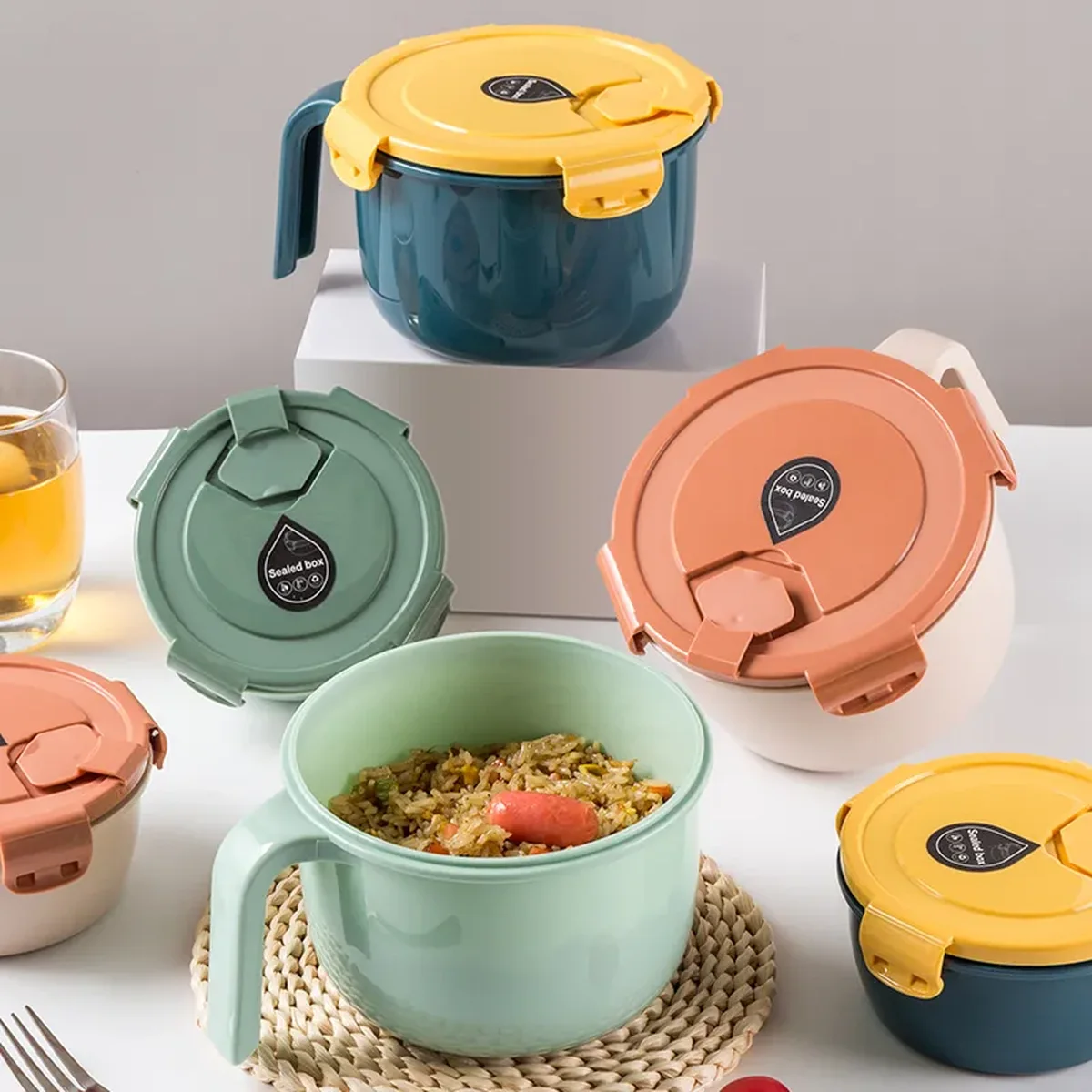 Round 1,200 ml PP ramen bowls with clip lids and side handles, in several body and lid colours, one opened and filled